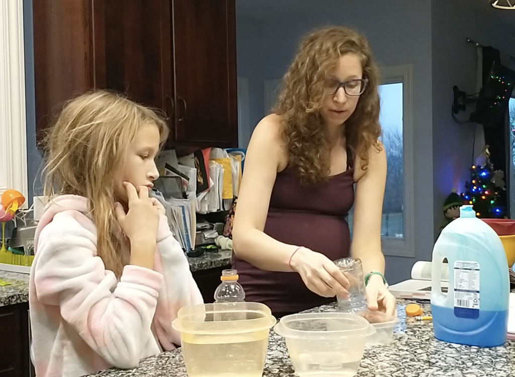 Dip open end of empty bottle into soap solution 